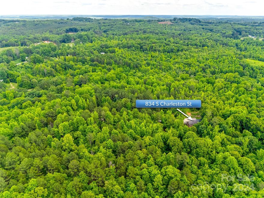 Welcome to this nature paradise! Explore 42.15 acres which includes the babbling sound of Doolittle Creek. Such a serene atmosphere. Wild turkeys and deer have been known to roam this property; it's like having your own personal wildlife sanctuary. Plenty of tall pines and hardwoods. A dream come true for any nature lover. The blank slate of the unfinished brick home offers endless opportunities for customization, turning it into your ultimate dream retreat. Two fireplaces add a cozy touch, perfect for chilly evenings surrounded by the beauty of nature.  Large brick back patio is the ideal spot for entertaining or simply unwinding and soaking up the natural splendor. It's a haven away from the hustle and bustle of everyday life-a place where you can reconnect with nature and find peace and tranquility. Make this home your dream home with a renovation loan. Home is at stud stage. Functionality of mechanicals is unknown. Vacant since 2007. Home sold AS IS. Cross listed: MLS #4147319.