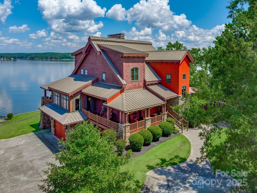 Premier Lakefront Estate on Lake Wateree – Now Even More Extraordinary with Added Acreage!

Experience the pinnacle of luxury lakefront living at Rockbridge Lodge — a breathtaking retreat that has just become even more exceptional. The property now includes two outstanding additions: a generous 1.37-acre sandy beach lot right on the main channel and a sprawling 17-acre upland parcel. Together, these bring the total to over 20 acres of pristine, private paradise — dramatically expanding your personal waterfront haven.

As you arrive, the lodge's impressive stone-and-timber facade commands attention, blending rustic elegance with timeless grandeur. Step inside to the soaring grand room, where a massive wood-burning stone fireplace anchors the space beneath dramatic timber-beam ceilings. This isn't just a home — it's a resort-like escape designed for unforgettable moments.

The luxurious master suite serves as your private sanctuary, featuring its own cozy wood-burning stone fireplace, expansive windows and doors framing stunning sunrise views across the shimmering lake, a generous walk-in closet, and a spa-inspired bathroom complete with a separate shower and relaxing jacuzzi tub.

Up the grand timber stairwell, additional bedrooms await, each with soaring ceilings and clever hidden nooks or lofts — perfect for extra sleeping space or playful hideaways. The home boasts three fireplaces in total, including one in a guest bedroom for added warmth and charm.

The lower level is an entertainer's dream: a versatile, expansive space with multiple seating areas, a pool table, game table, ping-pong, and a state-of-the-art HD projector with a 12-foot screen. Step outside through dramatic, arch-shaped castle-like doors to a large concrete apron — ideal for parking, outdoor gatherings, or overflow entertaining. A walk-in concrete vault offers endless possibilities, from a custom wine cellar and tasting
room to secure storage for the avid hunter's collection. The adjacent theatre room, with its stone walls and coffered ceiling, elevates movie nights to cinematic heights.

Outside, the amenities continue to impress: a large treehouse, boathouse, private boat ramp, RV hookups, irrigation system, and so much more.

This rare gem on one of South Carolina's most sought-after lakes delivers unmatched value and endless possibilities. Don't let this upgraded masterpiece pass you by — schedule your private tour today and discover your forever lakefront legacy!