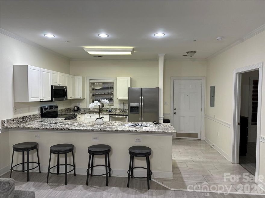 Don't miss the opportunity to see this stunning ground-level condo featuring 2 bedrooms and 2 bathrooms! The unit boasts brand new granite countertops, updated LVP flooring, ceramic tile, and fresh paint throughout. Included are stainless steel appliances, a washer/dryer, wooden blinds, and a Nest doorbell camera. The open floor plan seamlessly flows out to a freshly painted patio that overlooks one of the two community pools. Enjoy a prime location near restaurants, grocery stores, and a variety of retail shops. Heatherstone is also conveniently situated close to UNCC and just off Highway 485. Home warranty to be offered with accepted offer