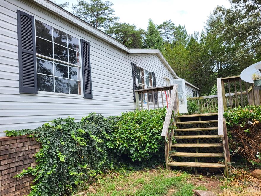 A lovely manufactured home on 2 acres nestled in a beautiful, rural, wooded area, providing a peaceful and serene environment. The home offers plenty of natural light and features an open floor plan with a spacious living room and family room, with a very practical and functional kitchen. Ample outdoor space to enjoy the surrounding nature. The home's rural location offers privacy and tranquility, with easy access to nearby towns and attractions. This is the perfect home for those seeking a peaceful retreat in a beautiful natural setting. Less than 15 minutes from Tryon International Equestrian Center, 17 minutes from Lake Lure, 18 minutes from Rutherfordton, and 24 minutes from downtown Tryon with quick access to Hwy 74. Lease Option or Rent to Own available.