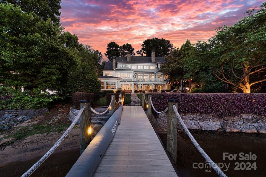 Nestled along the serene shores of Lake Norman, this waterfront masterpiece offers an unparalleled blend of luxury, convenience, and natural beauty. Just a short bike ride from both the prestigious Peninsula Country Club and Yacht Club, this custom built 5 BR home has it all. Large glass doors throughout offer panoramic views of the shimmering waters beyond. A gourmet kitchen and open-concept living area with multiple fireplaces provides the perfect setting for intimate gatherings and festive celebrations alike.The lower level is perfect for entertaining with a bar, fireplace, movie room, gym, fully climate controlled wine room and seamless access to the pool, lake and dock. Multiple porches and terraces beckon you to unwind and soak in the breathtaking views. Lounge by the sparkling pool, take a refreshing dip on warm summer days, or retreat to the pool cabana for shade and relaxation. As the sun sets, gather around the fireplace and savor the magic of lakeside living under the stars.