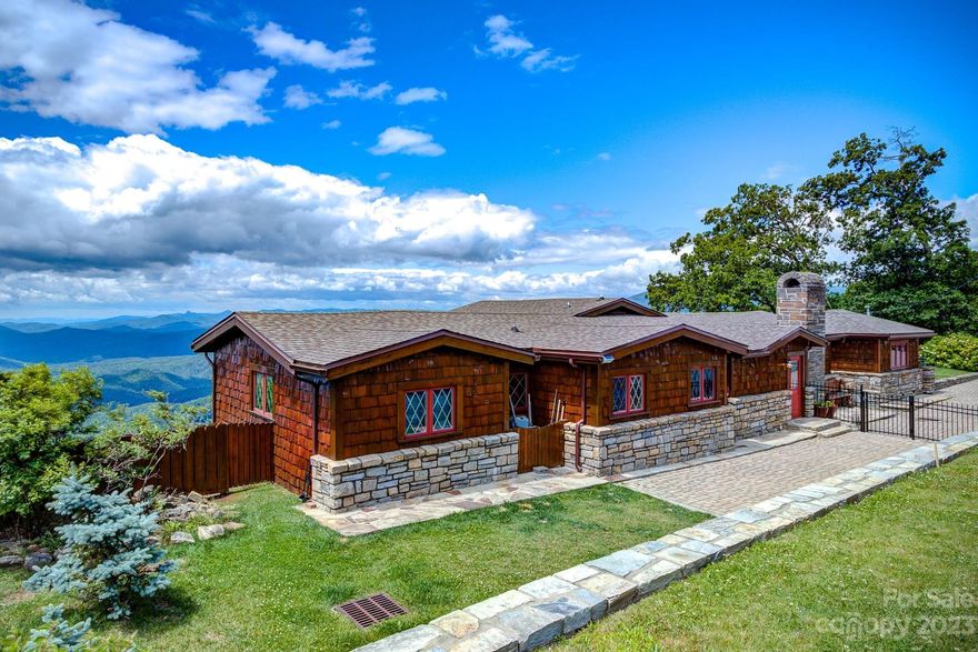 Classic Blowing Rock home with 180 degree LONG RANGE LAYERED VIEWS!  Enter to a warm and comfortable living room with new flooring, classic wood ceilings and walls, and a wood burning fireplace. Proceed to the open dining and large living area with floor to ceiling windows and VIEWS! The kitchen showcases a coveted propane AGA stove and granite counters. There are four bedrooms on the main level, three with their own baths. The main floor opens to upper deck through three separate exits to enjoy the view from the entire back of the property. The lower level is used as two bedrooms where you can wake up to the views from floor to ceiling windows. The primary suite has a cedar walk-in closet, shower, and a jetted corner tub. Both downstairs bedrooms outside entry to the decks. Step outside to the huge lower deck, stone firepit, and small garden area. In front of the house is a fenced yard. The home and all decks have just been stained and painted. New roof in 2019, HVAC replaced 2017.