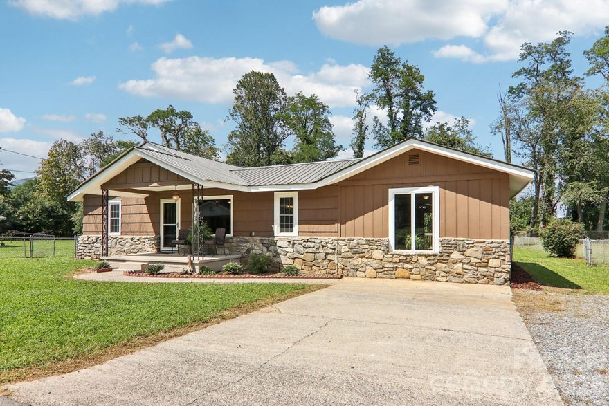 Welcome home to this beautifully renovated 3-bedroom, 2-bath ranch-style gem in the heart of Waynesville! Backing directly up to the Waynesville Inn and Golf Club, this home offers peaceful golf course proximity along with serene Richland Creek. Featuring true one-level living, the layout includes generously sized rooms, ideal for comfortable daily living or easy entertaining. Fresh interior and exterior paint add a modern, move-in-ready feel, while the durable metal roof ensures long-lasting protection and curb appeal. Start your mornings on the charming covered front porch, then enjoy the afternoons on the open back deck overlooking a level, easy-to-maintain yard – perfect for pets, play, or gardening. Inside, the home’s thoughtful updates complement the warm, inviting atmosphere throughout. Whether you're looking to settle into full-time living or a mountain getaway, this location offers both tranquility and convenience. Just minutes from downtown Waynesville’s shops, restaurants, galleries, and festivals, you'll also enjoy easy access to hiking trails, the Blue Ridge Parkway, and local breweries. Don’t miss this opportunity to own a slice of mountain-town charm and modern upgrades – schedule your showing today!