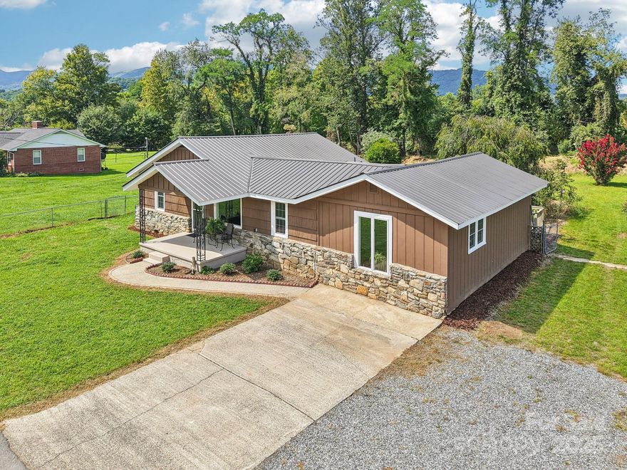 Welcome home to this beautifully renovated 3-bedroom, 2-bath ranch-style gem in the heart of Waynesville! Backing directly up to the Waynesville Inn and Golf Club, this home offers peaceful golf course proximity along with serene Richland Creek. Featuring true one-level living, the layout includes generously sized rooms, ideal for comfortable daily living or easy entertaining. Fresh interior and exterior paint add a modern, move-in-ready feel, while the durable metal roof ensures long-lasting protection and curb appeal. Start your mornings on the charming covered front porch, then enjoy the afternoons on the open back deck overlooking a level, easy-to-maintain yard – perfect for pets, play, or gardening. Inside, the home’s thoughtful updates complement the warm, inviting atmosphere throughout. Whether you're looking to settle into full-time living or a mountain getaway, this location offers both tranquility and convenience. Just minutes from downtown Waynesville’s shops, restaurants, galleries, and festivals, you'll also enjoy easy access to hiking trails, the Blue Ridge Parkway, and local breweries. Don’t miss this opportunity to own a slice of mountain-town charm and modern upgrades – schedule your showing today!
