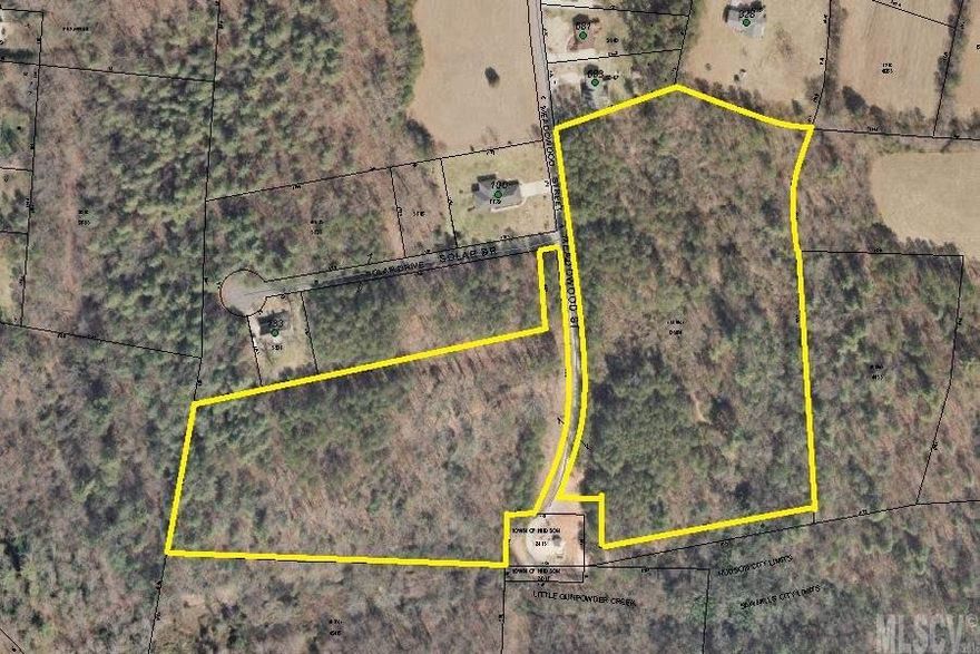 Property lies on both sides at the end of Meadowood St. Wooded, single family residential.