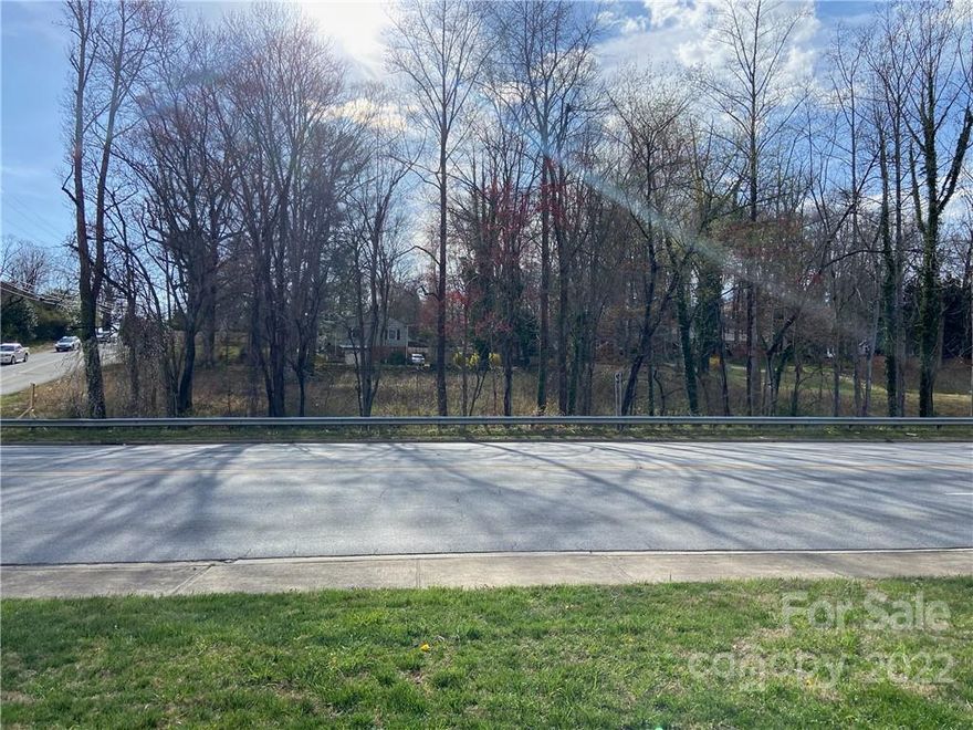 Great commercial lot on the corner of Highway 321/Blowing Rock Road and Hospital Avenue Northwest with a traffic light. Now with seller financing available for 5 years, interest only at 8% with 20% down. Woodland Place Northwest is on the backside of the property. The lot is mostly cleared with a few trees and offers a gentle slope. A building was demolished on the site, but the foundation and driveway remain. Lenoir is home to one of Google's data centers as of 2007. This lot would make a good place for a small office.