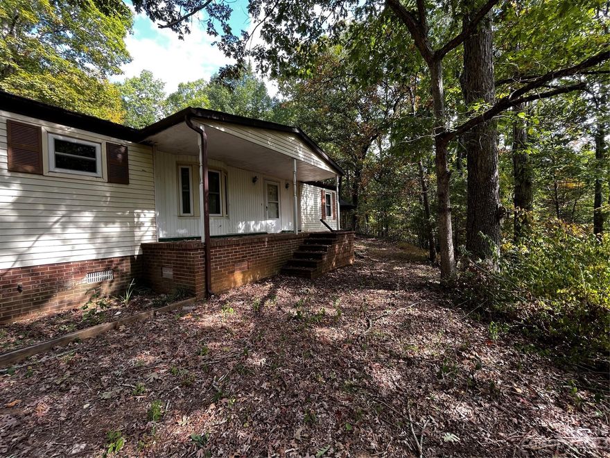 Looking for privacy??   Nice home on approximately 4.8 acres.  Needs some TLC but potential abounds.  Nice shop (22 x 36) with 2 garage doors.   3 bedroom and 2 baths; split bedroom plan.  Nice covered front porch and deck.  Creek runs through property.  There is an older building structure that was used as a gathering spot with a mini kitchen for family gatherings/cookouts.