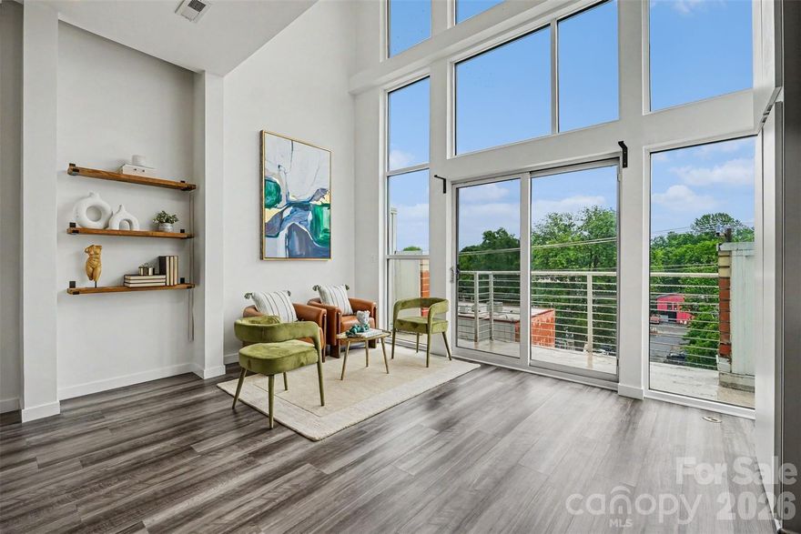 You don't want a cookie-cutter condo. You want soaring 20-foot ceilings, wall of windows, a balcony that over looks the NoDa vibe and a skyline view that reminds you every night why you chose this city. This is that place.

This loft condo drops you into the beating heart of NoDa — Charlotte's arts district and the city's most culturally alive neighborhood. The open floor plan and loft-style layout were made for the way you actually live: hosting friends before a show, working from home without feeling cramped, or just taking in the Uptown skyline from your own windows while the coffee brews.

Right outside, everything is already there. Steps to coffee, groceries, dinner, or a live show at one of NoDa's iconic venues. Grab churros at midnight. Hit the greenway for a morning run. The neighborhood moves at whatever pace you want — and so does your commute. The light rail is steps away, putting South End just 12 minutes out and Uptown even closer, no parking, no traffic, no problem.

Weekend plans write themselves from here. Paddle, kayak, or push your limits at the U.S. National Whitewater Center, just 20 minutes away. Charlotte Douglas International makes spontaneous travel genuinely easy at only 20 minutes from your front door. And when South End is calling — the breweries, the restaurants, the scene — you're there in under 15 minutes by car or a straight shot on the rail.

When you're ready to sweat closer to home, right next door is a fitness center. When you're ready to explore, the boutiques, murals, and art crawl are out your front door. This is a neighborhood with a genuine identity — and a condo that matches it.

Eclectic in spirit. Effortless in practice. Your HOA covers water and trash, the building's finances are solid with strong reserves, and a new refrigerator is already waiting for you. Two parking passes come with the condo.

NoDa doesn't have many homes like this. And once you're in, you'll wonder how you lived anywhere else.