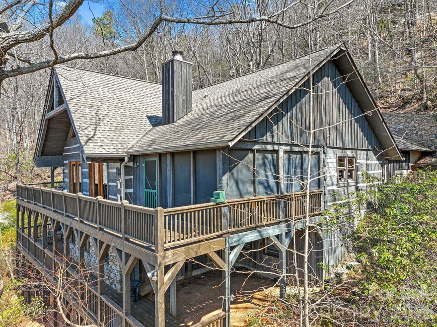 Perched at approximately 2,700 feet in elevation within the gated High Vista community, this beautifully maintained Bob Timberlake hemlock log home captures sweeping, layered views of the Blue Ridge Mountains and the quiet magic of mountain living. Set on .85 acres along a peaceful ridge, the home offers a rare combination of privacy, craftsmanship, and year-round scenery that changes with every season.

Built with impressive solidity and anchored into bedrock, the home reflects the warmth and authenticity of classic Timberlake design. Inside, rich wood tones, vaulted spaces, and large windows frame the surrounding mountains and invite the outdoors in. The atmosphere feels like a true mountain lodge retreat—warm, welcoming, and perfectly suited for both quiet mornings and lively evenings with friends.

The heart of the home opens to a spectacular screened porch and expansive rear deck stretching across the back of the house, creating the perfect setting for morning coffee, sunset dinners, or simply watching the clouds drift across the distant ridgelines. A thoughtfully placed fire pit area offers another inviting place to gather and enjoy the mountain air beneath the stars.

The kitchen features recently updated appliances, while the home has been meticulously cared for throughout, including exterior staining in recent years and a recently installed tankless water heater. The daylight lower level provides additional living space ideal for guests, recreation, or a quiet retreat. Additionally, each bedroom in the home features an ensuite bathroom and a mountain view.

Wildlife is part of everyday life here—deer often wander along the ridge and the surrounding woods create a peaceful natural backdrop that feels far removed from the pace of town, yet you are only minutes from Hendersonville, Asheville Regional Airport, and the restaurants and shopping of the area.

Located within High Vista, residents enjoy access to a vibrant mountain community featuring optional golf and social memberships, a clubhouse and restaurant, racquet courts, swimming pool, and an active calendar of events.

Whether you’re seeking a full-time mountain home or a peaceful Blue Ridge getaway, this exceptional log home offers the views, craftsmanship, and setting that define the very best of Western North Carolina living. Exquisite furnishings are negotiable. Come see this home today!