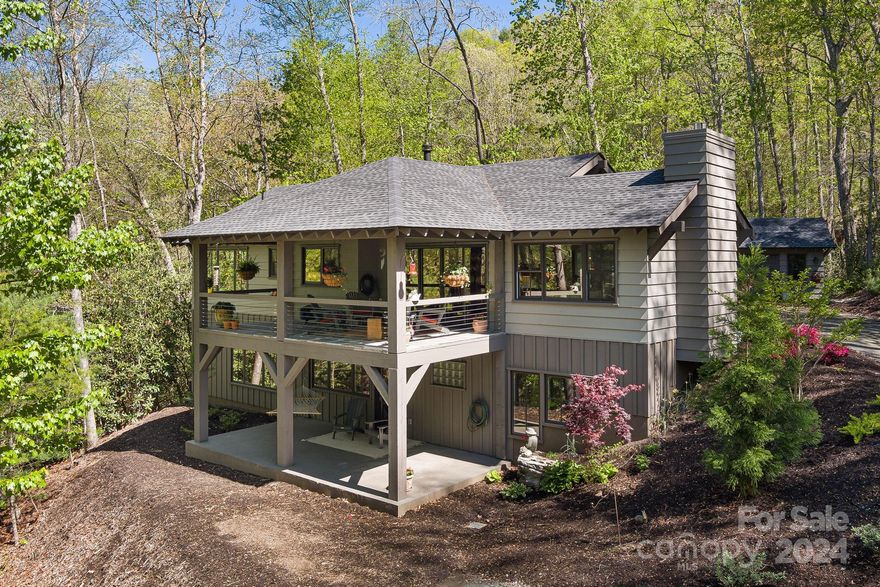 Wind down the tree lined drive to this bespoke mountain retreat nestled on a private 10 acres just minutes from downtown Hendersonville. This home will charm you with its superior craftsmanship and attention to detail. When an experienced home builder builds his dream home, it shows. The exposed wood beams, White Oak floors, 2x6 exterior walls, and covered flagstone deck are just a few examples of a home built to last. Energy-efficient windows and foam insulation promise substantial energy savings. Modern conveniences and contemporary style merge seamlessly with rich historical touches such as antique solid wood doors. The family room has a cast-iron wood stove surrounded by Tennessee stone that effectively heats the entire home.
The lower level has 2 bedrooms with full baths, a family room, small kitchen and flex space perfect for an Office/Exercise room. The 14x10 workshop matching the home's style could be used as an office or guest house.
New paved driveway complete.