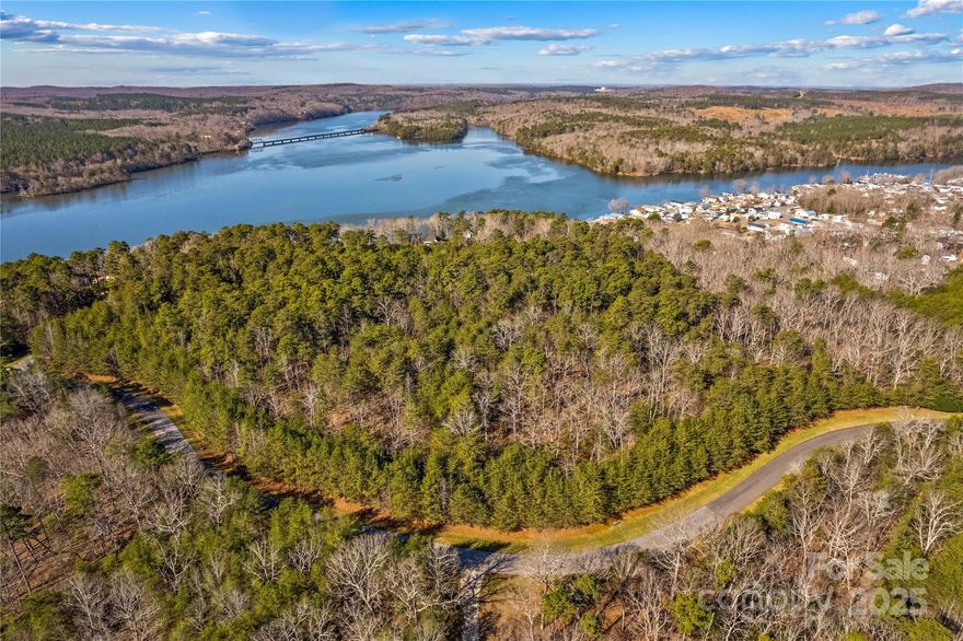 Located in the prestigious gated community of Heron Bay, this stunning lakeview lot offers a rare opportunity to build your dream home. Enjoy water views, privacy, and tranquility, with access to a boat slip for effortless lake adventures. This lot holds excellent potential for a custom retreat. Heron Bay offers outstanding amenities, including a private clubhouse, boat launch, walking trails, and optional boat storage. Stay active with pickleball just across from the clubhouse! Residents also have the option to join the nearby Old North State Country Club, home to a top-rated golf course, marina, restaurant, pool, and tennis courts.  Just an hour from Charlotte and Greensboro airports, this prime location is also near Uwharrie National Forest, perfect for hiking, biking, and ATV trails. Don’t miss this chance to own a piece of paradise in one of the area’s most sought-after lakefront communities!