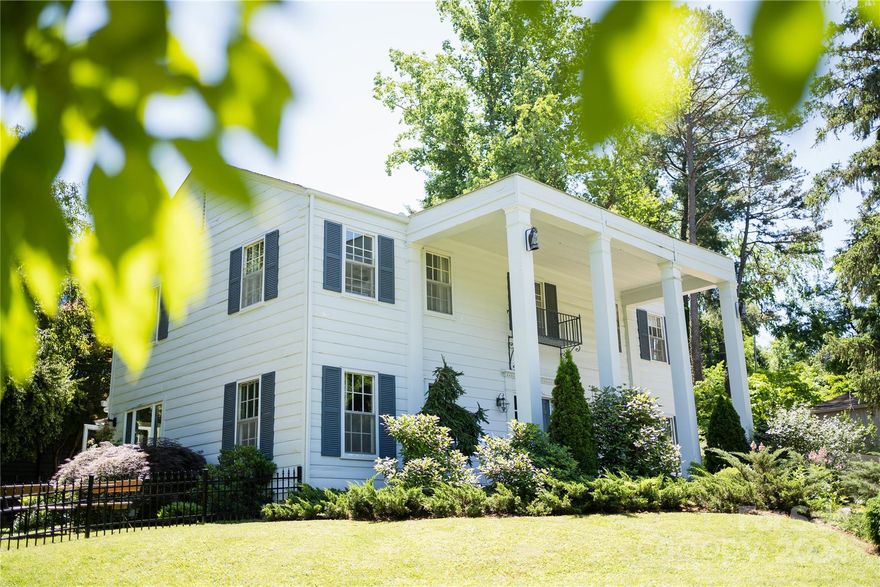 LAKEVIEW PARK! Nestled on a picturesque corner lot across from Beaver Lake, this stately home boasts classic architectural details blended with thoughtful renovations. Enjoy a brand new kitchen (completed April 2024), recently updated bathrooms, hardwood floors throughout, and a refurbished wood burning fire place.  The garage has been completely transformed into a versatile space, including a stylish home office, comfortable guest suite with loft, trundle bed and full bath and a sauna! It's perfect for relaxation and entertainment. The oversized back yard has been fenced for the safety of your pups without compromising the mature landscaping's beauty.  Lakeview Park residents enjoy easy access to walking trails, golf course and a bird sanctuary. Embrace the beauty of this highly sought-after location with its blend of natural charm and modern amenities, providing a peaceful retreat central to all North Asheville conveniences and minutes to Downtown Asheville.