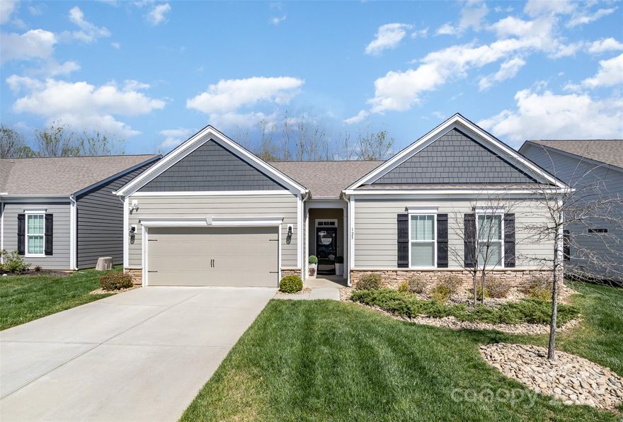 Welcome to this beautiful 4 bedroom, 2 bathroom home nestled in the highly sought-after Meadows at Coddle Creek.  Guests are greeted with an open concept living room with custom built shelving and luxury vinyl plank floors throughout most of the home.  Kitchen boasts a large granite island with matching countertops, complemented by a tile backsplash and smart stainless steel appliances.  Eat-in dining area opens up to a spacious screened in patio, offering serene wooded views and privacy.  Secluded primary bedroom, complete with an ensuite bathroom and large walk-in closet are an owners paradise. Split floor plan offers full bath and three secondary bedrooms, ideal for guests and/or home office.  Dedicated laundry room with custom built cabinets and wood countertops complete the rest of the home.  Residents can enjoy a range of community amenities including an outdoor pool, scenic walking trails, and a bocce ball court.  HOA manages lawn care and community areas.