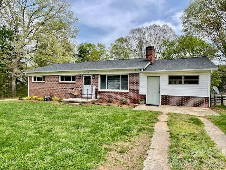 This full brick ranch offers solid construction and classic character in the Cajah’s Mountain area of Lenoir. Featuring 3 bedrooms and 1 full bath, the home includes an additional toilet and sink located separately in one bedroom, providing extra functionality and potential for reconfiguration. Another bedroom also includes a separate sink. Situated on nearly one full acre with a level yard and double driveways, the property offers convenient access and ample parking. Inside, you’ll find a nice sized kitchen, dedicated dining area, and living room with fireplace (the fireplace has not been used in years). The home retains its original knotty pine paneling dating back to 1957, along with mostly original hardwood flooring throughout. The common bathroom is functional but was in the process of remodeling and is currently missing some sheetrock and finishing touches. The original floor furnace is no longer operational; however, a newer heat pump package is in place, presumably installed in 2017. Additional updates include a 200-amp electrical panel upgrade completed in December 2025 and a new roof installed in December 2019. The home offers nearly 1300 heated square feet of living space plus nearly 400 unheated square feet, which includes a separate laundry room. This property is ideal for buyers looking to restore, renovate, or customize a home with strong bones, vintage charm, and a desirable location.