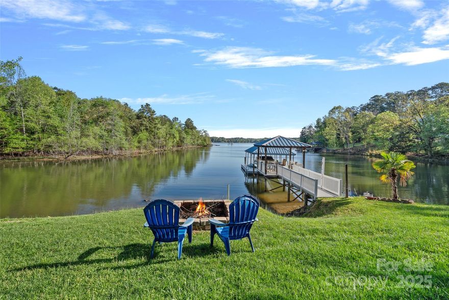 $10,000 in seller paid credits & up to 1% lender incentive with preferred lender!! Stunning lakeside retreat situated along the shores of Lake Wylie with nearly 200ft of shoreline in a private deep water cove! This home is truly an entertainer's paradise from the circular driveway, grand entry way, expansive outdoor veranda, built in gas grill & pizza oven, sizable backyard, 2nd story balcony with long range lake views, and covered sitting area on the dock perfect for relaxing & enjoying a glass of wine. Upon entry you'll notice the gleaming hardwood floors leading you into your cozy living room with a stone fireplace and newly upgraded chef's kitchen complete with a large island, gas cooktop, prep sink, quartz countertops & plenty of cabinet space. Primary retreat on main features bay windows overlooking the water, patio access & spa style ensuite. Upstairs you'll find a private guest suite, spacious bonus room, additional guest room & bath and bed/bonus perfect for a media room.