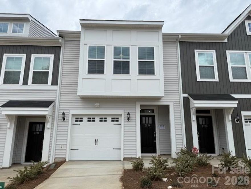 This delightful two-story townhome features three bedrooms, two-and-a half-bathrooms, and a well-planned open layout. The main floor is highlighted by soaring nine-foot ceilings and stylish luxury vinyl flooring, creating a bright and inviting atmosphere. The open kitchen includes a generous sink and ample space for cooking and entertaining with ease. Upstairs, the nine-foot ceilings continue, and the primary suite serves as a serene retreat complete with a walk-in closet, dual vanities, and a tiled walk-in shower with a corner bench—ideal for relaxing at the end of the day. Two additional bedrooms and a conveniently located laundry closet add comfort and functionality for everyday living.