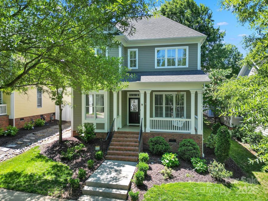 Prime location, only a short walk to the Village where you'll find shops, restaurants, wine bar, library, gym, & more! Enjoy relaxing on the charming rocking chair front porch. The home offers a main-level primary suite & three additional bedrooms upstairs. Both full baths feature double vanities. The spacious 4th bedroom has updated LVP flooring, can serve as a flex/office/bonus space. The kitchen is equipped with a 5-burner gas stove with double oven, & stainless steel appliances. Low-maintenance backyard with artificial turf & a vinyl fence. Two-car garage includes pull-down attic & shelving, plus a second attic & storage in the 4th bedroom. Extra parking with a pad beside the garage. Tankless water heater. New Roof in 2025. New HVAC in 2024. Exterior Painted in 2024. Water pipes replaced in 2021. Baxter rich amenities include 2 pools, tennis, 4 playgrounds, parks, walking/biking trails & tons of activities for all ages. Award-winning schools & low SC taxes! Assumable Loan Option.