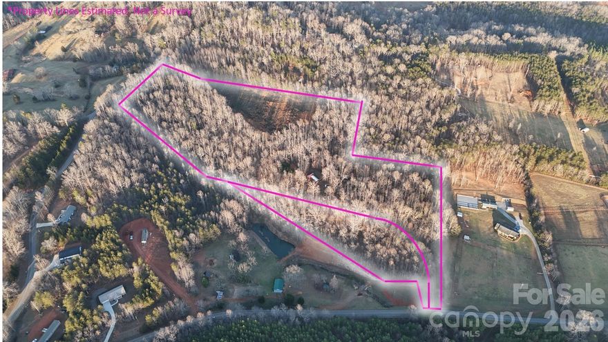 This exceptional ±19.87-acre property along Bill Collins Road presents a remarkable blend of privacy, accessibility, and unlimited potential in the heart of Polk County; Columbus Tryon Area. With no restrictions and mixed-use zoning, this property serves as an ideal canvas for the most discerning buyer—whether your vision includes a grand private estate, multi-generational family compound, equestrian or farm property, or a thoughtfully planned residential development.

The land is beautifully appointed with an established driveway from Bill Collins Road, providing access to a private primary homesite already improved with underground power, a well and 4-bedroom septic system. The homesite is perfectly positioned to stunning mountain views, offering an exceptional setting for a custom residence.

A large open tall fescue pasture, combined with gently rolling topography and mature tree buffers, creates a sense of openness and privacy that is increasingly rare. The property’s layout and terrain reveal numerous opportunities for additional homesites, making it well suited for future expansion or development.

The lower portion of the property features a natural spring, a creek, and established walking trails, enhancing the land’s serene, park-like character and recreational appeal.

All essential infrastructure is in place and ready—site-built home, manufactured home, or camper/RV hookup can easily be established, allowing for immediate enjoyment or phased development. This is a property where much of the time-intensive groundwork has already been completed.

Ideally located just minutes from downtown Columbus, the Hwy 74 bypass, Lake Lure, and the Tryon International Equestrian Center, this property offers refined country living with convenient access to the premier destinations of Western North Carolina.

Opportunities of this caliber are exceedingly rare in Polk County. Whether preserved as a legacy estate, cultivated as a working farm, or developed into an exclusive residential enclave, this property offers sophistication, flexibility, and enduring value. Owner is a licensed Realtor.