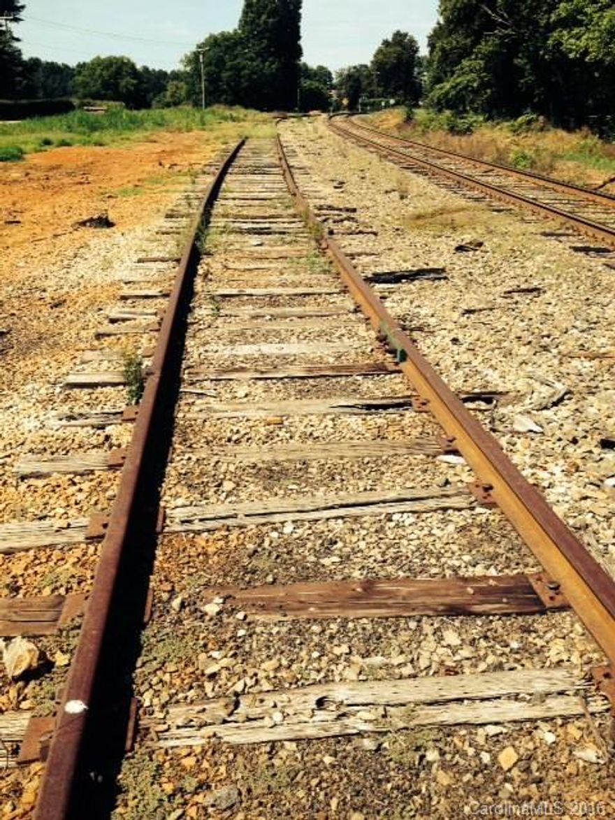 Railroad Spur with approximately 400 feet of track connecting to Norfolk Southern System.  Formerly used to load grain onto railroad cars.  Grain elevator has been removed & tracks have not been in use for 3 years.  Priced well below reconstruction.  Agent has estimate for needed upgrades.  RR cars are approximately 60 long.
415 feet of frontage on HWY 801 and 387 feet of frontage on the rail tracks.  Very unique piece of property with a hard to find use in the vicinity of Charlotte, NC.