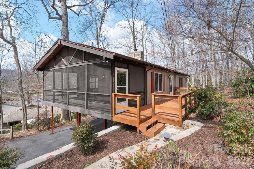 Nestled in the sought-after Lake Junaluska Assembly, this charming mountain retreat offers the perfect blend of privacy, character, and seasonal lake views. Set on a gently sloping, wooded lot, this 4-bedroom, 2-bath home invites you to experience peaceful living surrounded by nature.

Step inside to a warm and inviting interior featuring vaulted ceilings, rich wood finishes, and expansive windows that bring the outdoors in. The spacious living area is centered around a cozy wood-burning fireplace, creating the perfect setting for relaxing evenings. The home’s thoughtful layout includes a main-level living space plus a finished basement, offering flexibility for guests, and hobbies.

Enjoy the beauty of the mountains from multiple outdoor spaces, including a covered front porch, side porch, and a screened porch, ideal for morning coffee or evening gatherings. In the winter months, take in stunning views of the lake and surrounding mountains.

Whether you’re searching for a full-time residence, mountain getaway, or investment opportunity, this home offers timeless appeal in one of Western North Carolina’s most beloved lake communities.