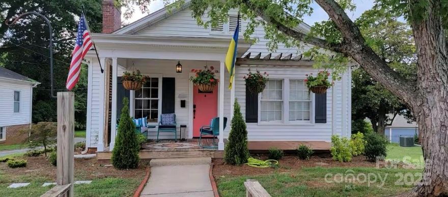 This beautifully renovated 1920's timeless bungalow in the Historic District of charming downtown Belmont, is going to steal your heart!  At just under 100 years old, this enchanting home features all the renovations you want, along with the charm of centuries past.  Two spacious bedrooms, each with their own private full bathrooms, spacious living room with wood burn fireplace, inviting dining room for entertaining, wonderfully functional kitchen with beautiful accents, and stainless steel appliances.  Relax in the bright and cheery sunroom, or step out onto your rear deck over looking your fenced rear yard.  Need room for storage?  No worries!  This adorable bungalow includes a full basement with area for a gardening bench, workshop, and more!  To make this home even better...its within easy walking distance of Main Street Belmont!  Enjoy shops, wonderful restaurants, a beautiful park, and character galore!   This is a dream home!