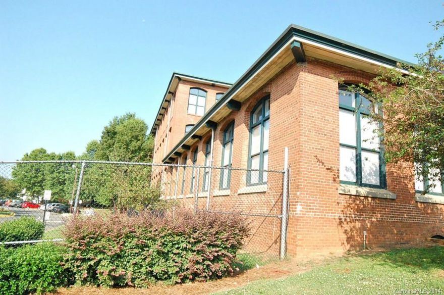 Your Urban Oasis!  Located in Historic Hoskins Mill…  2 Story Loft offers Exposed Brick, Soaring  20ft ceilings with huge windows,  Large loft/bedroom overlooks Great room, Main Level includes Kitchen, Den, One bedroom and bath.  Community Terrace and Secured Building access along with a Central Laundry Facility and Exercise Room.  Parking lot gates are closed at night for added security. Drapes DO NOT CONVEY. Not a short sale or foreclosure.