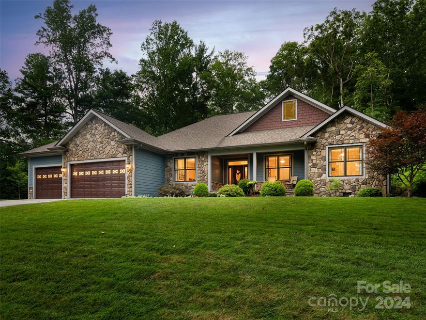 Conveniently located near Fletcher Park, I -26, and the Asheville Airport, this exceptional custom home invites you in with its elegant features and thoughtful design. The primary bedroom includes a tray ceiling with bay window and a stunning picturesque view, spacious walk-in closet and beautiful bathroom with whirlpool tub and large shower. Two additional bedrooms provide flexibility for guests, recreation or a home office. The kitchen is adorned with stainless appliances, granite countertops, custom cabinetry and an eat-in space perfect for culinary enthusiasts. An expansive living room features a gas fireplace with granite façade, large windows, and archways to an open floorplan creating a cozy, tranquil atmosphere. Adding to its charm, a sunroom provides an area to relax and unwind and a spacious three car garage including an extended bay for oversized vehicles/boats and workbench with cabinets. Enjoy the meticulously landscaped grounds featuring a wide variety of foliage.