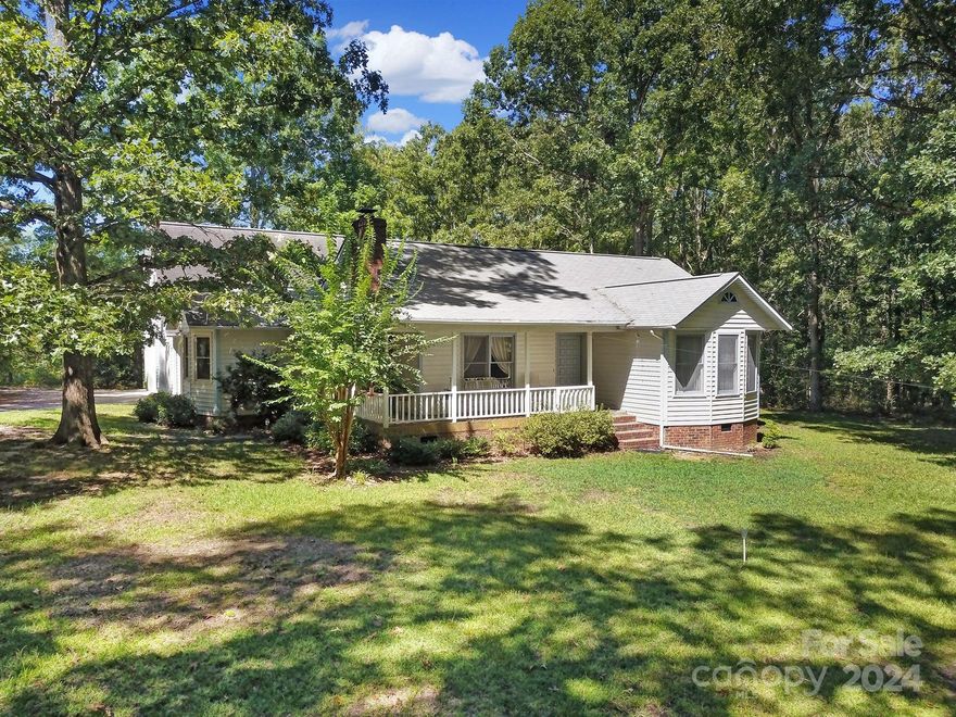 Great privacy with this well kept home on 2.85 acres.  The main part of the house has 3 Bedrooms and 2 Full Bathrooms with an additional 1 Bedroom and 1 Full Bathroom over the large 2 car garage.  There is a bonus room over the garage as well.  There is a wraparound front porch and a screened in back porch.  There is an attached carport on 1 side of the garage and a detached wired workshop too.  The Great Room has a vaulted ceiling and a beautiful wood burning fireplace.  All appliances included with a new refrigerator.  The washer and dryer are included and the main part of the house has a new HVAC installed 16 months ago.  A must see!