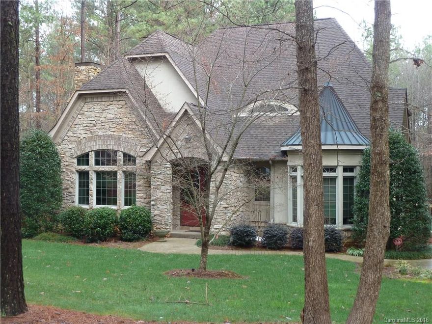 Lovely, elegant Custom built English Style "cottage" with great wow factors! Beautiful hardwoods, dramatic two story entry, custom moldings & built-ins throughout. Stunning architectural details. Huge, master suite with seating area on main level. Upstairs sitting room/loft can convert to 4th bedroom. All bedrooms are oversized, en-suite with walk in closets.  Fabulous custom kitchen with upgraded features and appliances. Huge walk in attic. Deeded boat slip #2 a short walk down the path.