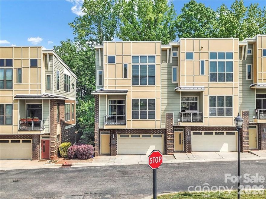 Beautifully updated end-unit townhome in Steel Gardens, offering stylish upgrades and abundant natural light. Thoughtfully renovated with modern design touches throughout, this home features an open-concept living space centered around a sleek kitchen with black quartz countertops, stainless steel appliances, and a striking waterfall island that anchors the space. The living area is enhanced by soaring ceilings and a custom built-in media center with generous storage, creating both function and visual appeal.

The main level includes access to the two-car garage and inviting outdoor spaces, including a private back patio and cozy balcony - perfect for relaxing or entertaining.

Upstairs, both bedrooms feature en-suite bathrooms, recently refreshed with new paint and mirrors, along with a conveniently located laundry area.

This end-unit position provides added privacy with no homes directly in front or behind, thanks to a large greenspace and guest parking area. Located just moments from the heart of NoDa, you'll enjoy easy access to some of Charlotte’s best restaurants, breweries, galleries, music venues, and neighborhood hotspots.