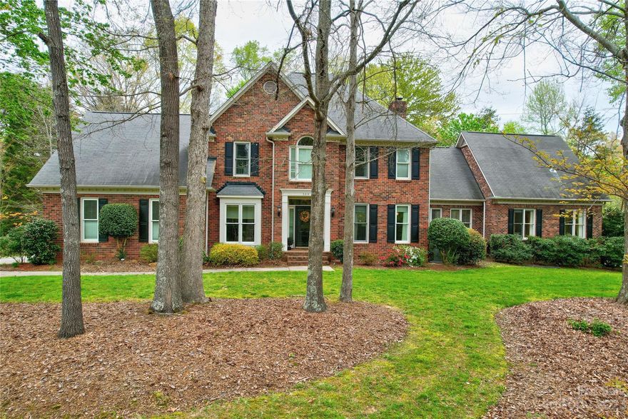 Multi-generational living space w/2 primary bedrooms, 2 bonus rooms or 6th bedroom. Full brick home nestled on 1.38 acres backing onto utility easement. Outside space for sporting games, dual driveways w/extra parking and or b/ball games plus fenced area. Stone patio and deck for outside entertaining. The warm interior offers, cozy flex/living room, & formal dining room. Family room with coffered ceiling, gas fireplace.   Kitchen with s/s appliances, granite, gas range & walk-in pantry.  Separate living area for guests and/or in-laws with private den, large bedroom w/walk-in closet and private bath. Mud rm/laundry from garage & rear yard.  Primary bedroom offers 2nd laundry area, walk in closet. Primary ensuite w/dual vanities, garden tub & separate shower, overlooking private rear yard. Bonus room with built-in storage, great for games & movies and private staircase from kitchen. Bonus/6th bedroom w/private staircase and full bath.  Convenient to I485.