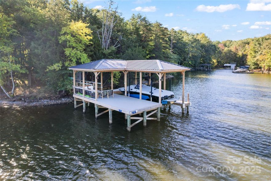 Get ready to be WOWED by this gorgeous, long-range panoramic view lot on Lake Wylie and zoned for TOP ranked Clover schools.  Conveniently located off of Charlotte Highway and right over the Buster Boyd bridge, this home is set back so you not only enjoy your private lot but you are tucked away in your own oasis.  This big water view lot, is located on a point so you enjoy deep water that is perfect for your recently built dock with cover and entertainment area.  The dock was built in 2023 and is fully permitted by Duke Energy and includes the boat lift.  The lot is fairly flat and perfect for a basement or slab home.  This lot allows you to immediately enjoy your lake access and the no time limit build with NO HOA gives you the flexibilty to build on your schedule.
See attachments for survey, Perc Test and Deed Restrictions.
