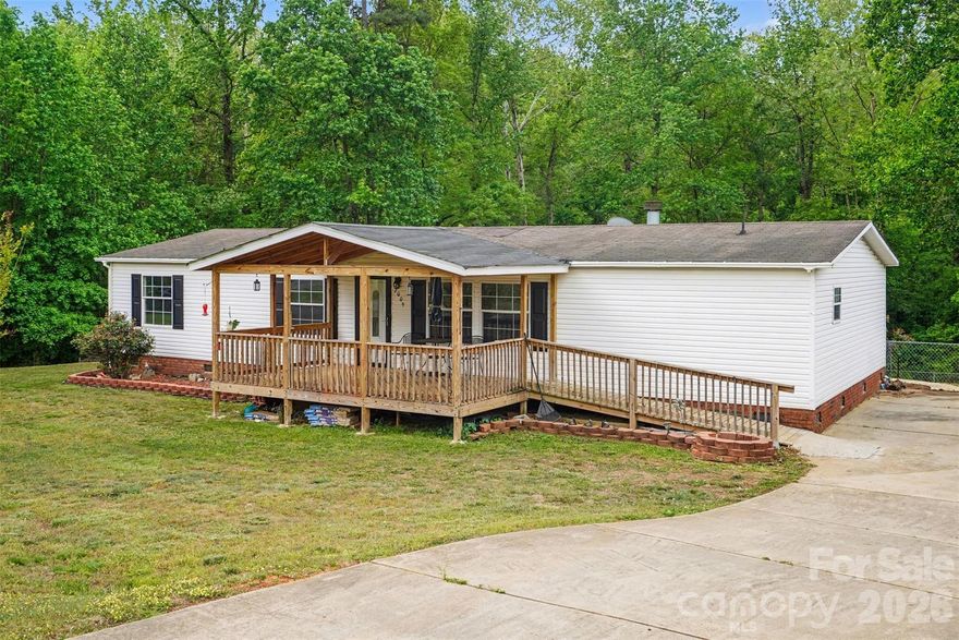 Manufactured home opportunity in Dallas with room to make it your own. This property sits on a large lot with a fully fenced backyard, spacious driveway, large front porch, large back porch, storage shed, and a nice partial wooded view that gives the backyard a little extra breathing room. Inside, the home offers a large primary bedroom with two walk-in closets, a spacious primary bathroom with separate tub and shower, and room to add a double vanity if desired. Both additional bedrooms also feature walk-in closets, giving everyone actual storage — a rare and beautiful thing.The home needs TLC, but key features are already in place, including updated flooring approximately 5 years ago, HVAC approximately 5 years ago, blinds on all windows, a functioning wood-burning fireplace, and appliances that convey, including the refrigerator and dryer. The large backyard and porch spaces give this home great potential for outdoor living, pets, gardening, or simply having space that does not feel like your neighbor is part of the floor plan.Located in Dallas, NC, this property offers a quieter setting with convenient access to Gastonia, US-321, I-85, Gaston College, Historic Dallas/Town Square, parks, shopping, dining, and regional attractions throughout Gaston County. Bring your vision, your contractor, and maybe your Pinterest board — this one has the space and location to be worth the effort.