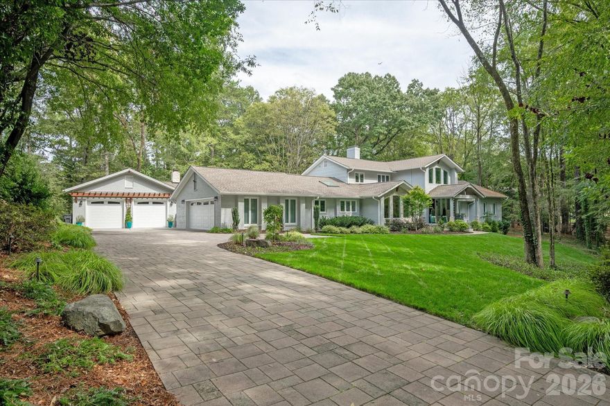 Rebuilt Gem in Prime Location with Views of Nature, Not Your Neighbor. Nestled on a private 1.45-acre estate in prestigious Pellyn Wood, this residence was architecturally reimagined in 2021 to harmonize modern sophistication with its park-like surroundings. The extensive transformation added a new primary suite, living room, and 2 car detached garage while updating every major system and finish, providing years of low maintenance living. 
The journey begins in the commanding two-story foyer, where floor-to-ceiling glass dissolves the boundary between the interior and the landscape. Organic white oak flooring leads to the heart of the home: a chef’s kitchen anchored by a massive social island and a professional Dacor suite. Outfitted with leathered dolomite counters, 48” gas cooktop, double ovens and a discreet prep scullery, it is a space designed for seamless, high-scale entertaining. The primary wing serves as a private retreat, positioned to capture an adjacent pond’s peaceful horizon in constant view. The spa-like en-suite balances sleek matte black with polished copper finishes, evoking a modern, timeless, curated, high-design aesthetic. This same peacefulness defines the family room, where walls of glass act as living picture frames to the outdoors, offering a "city-tranquility" balance that feels worlds away from the urban bustle.

Outdoor living is elevated on the expansive paver terrace, featuring a built-in grill and a monumental fireplace for starlit evenings. For the collector, the estate offers a rare four-car capacity, including a detached, climate-controlled garage with epoxy flooring.  

Perfectly balanced between the energy of Uptown and the prestige of Ballantyne-and just moments from SouthPark’s world-class amenities-this masterfully finished estate offers the rare caliber of new construction peace of mind within a secluded private sanctuary.  Right location. Right Size. Renovated right.