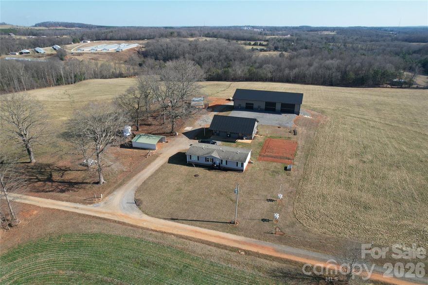 Exceptional equestrian and farm property ideally located just 2 miles off Hwy 421, 3.5 miles from I-77, and only 12 minutes to Yadkinville. Enjoy the convenience of being 40 minutes to Winston-Salem while surrounded by peaceful countryside and just minutes from several local vineyards. The property features approximately 300 feet of creek frontage along North Little Hunting Creek and offers access via Templeton Drive to Gregory Drive.

The land includes 28–30 acres of fully fenced pasture, ideal for horses or livestock, along with multiple well-built agricultural and shop structures. The main agricultural barn offers 6 stalls with room to expand to 7, a wash area, tack room, and a 38x55 horse stall area with a 55x12 overhang. A built-in BulkTech feeder adds efficiency for livestock operations. All agricultural structures have passed Yadkin Electrical inspection.

Improvements include an impressive 32x48 three-bay insulated shop with 9x48 overhang, spray-foam insulation, attic shelving, and plumbing in place for a future bathroom (no septic installed for the shop). Additional structures include a 48x36 garage/shop, 38x64 workshop, 48x45 downstairs shop with concrete floors, LED lighting, and roll-up garage door, and a pole barn.

The residence is a 26x56 mobile home built in 2018, offering 4 bedrooms and 2 bathrooms. The refrigerator and stove convey, providing a move-in-ready option for full-time living or farm management.

This versatile property is well-suited for equestrian use, farming, workshop-based businesses, or those seeking a private rural retreat with excellent access to major highways and nearby amenities.