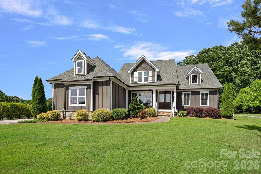 Rare opportunity on .72 private acres with no HOA and no Huntersville town tax. This farmhouse-cottage home is a cut above standard new construction in every detail. Step outside and the air changes. The space between homes here is something you can feel and breathe. It starts at the front door. Custom double doors, mostly glass, flanked by gas lanterns on each side, and a covered front porch where the sunsets are the kind that make you cancel whatever you had planned. Step out back to the sounds of the waterfall spa (heated), birdsongs, and Carolina blue skies above the tree canopy create a setting that is experienced before it is fully described. The private outdoor shower, garden, fruit trees and covered porch make staying home feel intentional. Main-level primary suite overlooks the saltwater pool (can be heated from spa) and tree-canopied backyard. Primary bath features dual vanity areas, soaking tub, oversized tiled shower with full-length bench, and walk-in closet with window. Open floor plan with gas fireplace, sliding doors to covered porch overlooking pool and spa. Kitchen includes walk-in pantry, coffee and beverage station, and large dining area. Drop zone, laundry with cabinets and counter, dedicated office, open loft, and large unfinished storage area with bonus potential complete the floor plan. Upstairs, two spacious bedrooms each with walk-in closets. One has a private en-suite bath. The other is served by a full hall bath. The open loft is a true flex space with a living area plus room for a study nook, reading corner, creative studio, or whatever this chapter of life calls for. Two unfinished storage areas, including one that is genuinely massive with real potential for a future finished space. Attached in-law or guest quarters includes full kitchen, laundry, bedroom, full bath, living area with gas fireplace, covered porch, and separate side entry with adjacent parking pad. Three-car side-load garage. Outdoor living features travertine surround, sun shelf, waterfall spa, outdoor shower, garden beds, fruit trees, and blackberry bushes. Craftsmanship throughout: hardwood floors, shiplap, marble detail, herringbone tile, copper ceiling detail, LeGrand switches, custom trim, and gas lanterns. Zoned for JV Washam Elementary, Bailey Middle, and Hough High. Minutes to Davidson, River Run, and the new Publix corridor.