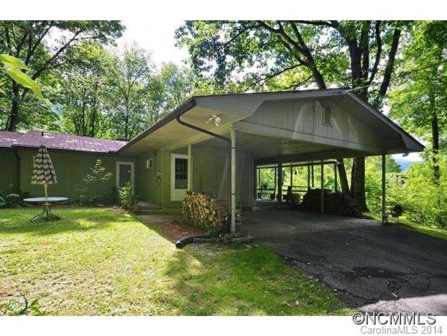 Must see to appreciate! Private setting. Beautiful red oak floors on the main level, striking stone WB fireplace in the open living room, large dining room and walls of sliding glass that open to an expansive covered deck across the length of the home. The lower level, which could be used as guest quarters, feature a spacious family room with brick gas FP, bath with tile shower and sauna. Creek on property!