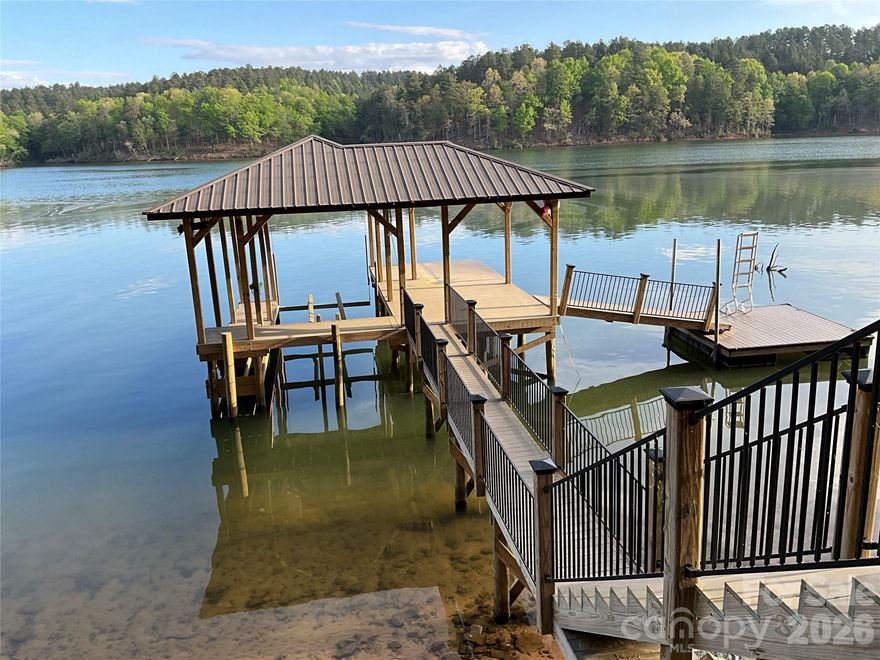 Ready to build with boat dock, water frontage landscaped, and a sea wall already in place to enjoy the lake this summer.  Check out this beautiful lake lot on Lake Rhodhiss in the Harbor Ridge subdivision located at 105 Beacon Ridge Dr with 1.304 acres and 186.25' of main channel lake frontage.  The owner has everything in place already to start building your four bedroom dream house on this lakefront lot in this gated community. This parcel offers main channel living on Lake Rhodhiss, a piece of Heaven known for its peaceful waters and recreational fun.  A great opportunity to create a custom lake estate with beautiful sunrise and sunset views.  Come enjoy the lake life to the fullest where nature meet conveniences.  Lake Rhodhiss is know for boating, fishing, kayaking, or simply swimming in the calm waters. Harbor Ridge Subdivision is a gated, estate-lot subdivision on the south side of Lake Rhodhiss, known for its wooded 1+ acre homesites, strong architectural standards, and community lake access amenities. It’s one of the more established and desirable Lake Rhodhiss communities, positioned in Connelly Springs / Rutherford College with convenient access to Hickory, Morganton, and I-40 to travel to Asheville or Charlotte.