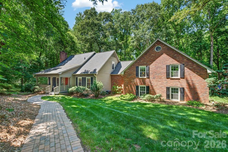 Nestled on more than 2½ private acres in sought-after Olde Williamsburg Village, this beautifully maintained single-family home offers a rare blend of natural beauty, warmth, and comfortable living. From the moment you enter the welcoming foyer, you’ll appreciate the inviting atmosphere and thoughtful design. Rich hardwood flooring throughout most of the main level adds timeless character and warmth. At the heart of the home is the beautifully remodeled kitchen, designed for both everyday living and entertaining. Open to the dining area, it features a stunning granite island perfect for gatherings with family and friends. An authentic old-brick wall with distinct architectural details showcases the built-in microwave, oven, and five-burner gas cooktop, creating a distinctive focal point. Abundant storage abounds with three pantries, a blind-corner swing-out organizer, and a cleverly concealed pull-out TV cabinet. French doors lead to a secluded screened porch, an ideal spot to relax while enjoying peaceful views and the sounds of nature. A spacious Trex deck provides additional outdoor entertaining space, while a second upper deck offers access from the recreation room. Above the spacious two car garage, an expansive recreation room features beautiful tongue-and-groove cathedral ceilings, a loft, full bath, and office nook, all ideal for guests, a home office, recreation room or multi-generational living.The primary suite on the main level includes an adjoining dressing/vanity area and a generous walk-in closet. Upstairs, two additional bedrooms share a full bath and a large linen/flex space. All three bathrooms have been tastefully updated.  The home's exterior is cedar siding and brick.  Also the property’s mature, low-maintenance landscaping enhances both beauty and privacy. Additional recent upgrades include crawl space encapsulation, new brick walkway, Trex flooring on front porch and rear deck and a new HVAC system (2026).  Experience peaceful, private living with unique architectural character and modern updates — all within the charm of Olde Williamsburg Village and the top-ranked school district in the state.
