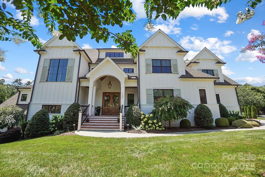 Meticulously designed seven-bedroom home in Davidson, where every detail has been thoughtfully curated. The chef’s kitchen boasts an island w/quartz countertops, two sinks, gas range, oversized refrigerator, and custom cabinetry. The kitchen opens to a large dining area and great room w/ fireplace. Outside, find a screened-in porch w/ fireplace plus a patio. The main-floor study, bedroom with ensuite bath, large drop zone and laundry complete this level. Upstairs, the primary suite is a true retreat, featuring a spa-like bathroom with marble, custom tile work, and a massive custom closet. Three additional large bedrooms share two beautifully appointed full baths and a recreation room. The walk-out basement includes a second primary suite, full kitchen, family room w/ wood burning fireplace, plus an additional bedroom and full bath. From custom millwork to designer light fixtures, this professionally designed home is filled with high-end finishes throughout. Don't miss seeing this home.