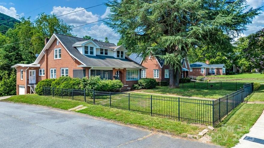 Charming 1929 Brick Beauty in the Heart of Town.  Step back in time with this classic 4-bedroom, 2-bath home, where historic character meets city convenience.  Nestled behind a gated front yard, you are greeted with a spacious screened-in front porch, perfect for relaxing and enjoying the neighborhood breeze.  Inside, you'll find original architectural touches and generous living space, ideal for entertaining. Fully repainted interior including windows.  Add. parking behind the shrubbery.  IDEAL area to build a garage with bonus room OR a large deck off the back of the house. Loc w/i city limits, enjoy the ease of sidewalk access to downtown - shopping, dining & local events just a stroll away. With a large rear area perfect for a future garage, this property offers both charm & potential.  Don't miss this opportunity to own a piece of history in a well-loved neighborhood.  Basement incl pull in garage sq ft.  Upper level cooled by forced air and window units.  Heat forced air only.