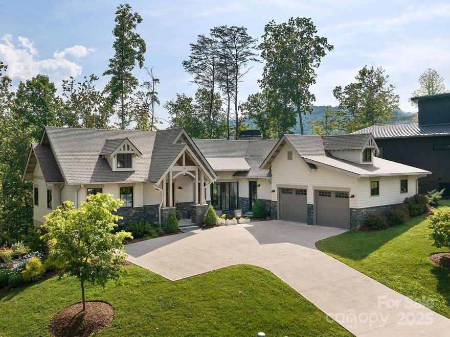 Nestled in the sought-after Riverbend Forest community, this architecturally stunning home by award-winning Sulaski & Company offers a luxurious lifestyle in an unbeatable location. Enjoy sweeping views of the Craggy Mountains and the Swannanoa River. The open-concept layout blends warmth with modern sophistication, featuring a gourmet kitchen perfect for culinary enthusiasts and spacious bedrooms designed for comfort and relaxation. A beautifully crafted wine cellar adds a touch of elegance.Step outside to discover thoughtfully designed outdoor living spaces ideal for entertaining—complete with a hot tub, bocce ball court, raised garden beds, and panoramic river views. Home also comes equipped with a whole house generator. Just minutes from downtown Asheville, the VA Hospital, Black Mountain, and the Blue Ridge Parkway, this extraordinary home offers both convenience and serenity.