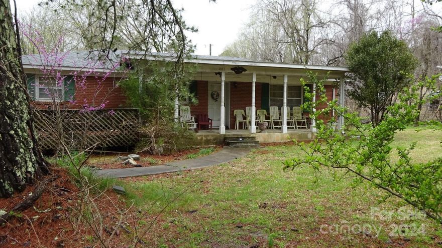 Investors take a look!  Beautifully wooded one acre lot with a  Solid built all brick home with several outbuildings for storage and parking. Completely fenced. Great potential!