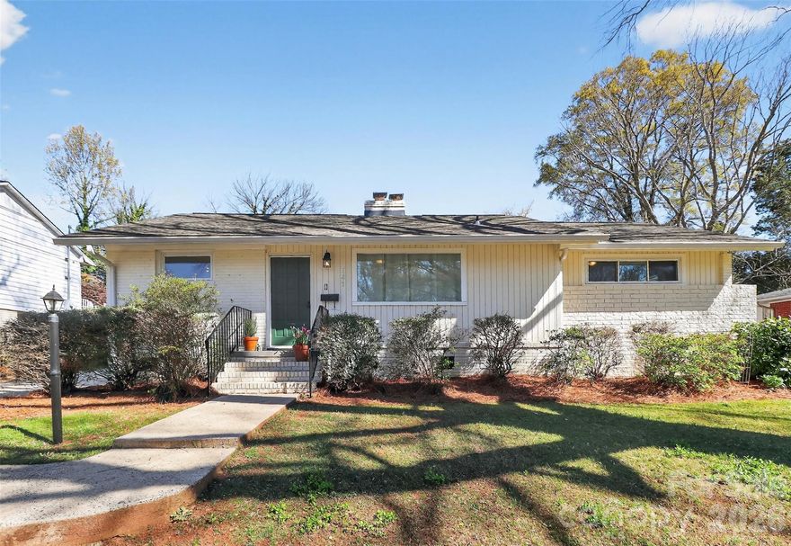 Welcome to this mid-century painted brick ranch in the highly sought-after Madison Park neighborhood! This charming 3-bedroom, 2-bath home blends classic character with some modern updates.  Step inside to find hardwood floors throughout most of the home, along with fresh interior paint (except the utility room). The inviting living room features a fireplace (chimney and gas logs sold as-is). The updated kitchen showcases freshly painted white shaker cabinets, quartz countertop, stainless steel appliances, and a pantry cabinet for added storage.  Appliances include glass-top range, microwave, dishwasher & refrigerator.  Separate dining room/area.  The primary suite offers an updated bathroom with an oversized shower, newer vanity, and tile flooring. Two secondary bedrooms share a hall bath featuring original decorative tile, a tub with tile surround, single vanity, and a large linen closet.  The sunroom has durable LVP flooring and provides flexible living space; it opens onto a deck overlooking the fenced backyard, ideal for relaxing or entertaining.  Additional features include an unheated utility room and a detached 2-car garage with a large 20' x 9' storage/workshop area, perfect for hobbies or additional storage. The fenced rear yard offers both privacy and functionality.  Enjoy the unbeatable location—walkable to restaurants, shopping, and entertainment, and just minutes from Uptown, South End, SouthPark, CLT Airport, and major thoroughfares.  Convenience truly meets comfort in this Madison Park gem!  Washer/dryer remain, Tankless Gas Water Heater 2026, HVAC 2018 per previous owners, Roof 2020. Crawlspace sealed and dehumidifier was installed, work performed within the past 6 months. House windows (with exception of front picture window and BR3 windows) have been replaced.