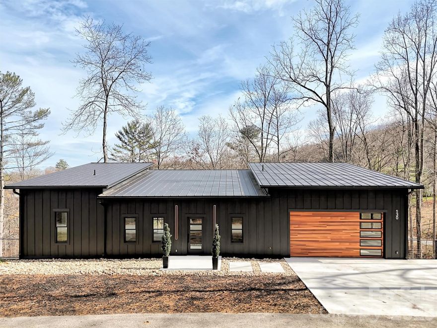 Price reduced and now includes an adjoining 1.01-acre parcel for over 1.7 total acres. This new 3-bedroom home with long-range mountain views was completed in 2025 and offers over 2,800 square feet of finished space across two levels. The main level features a vaulted living room, designer kitchen with walk-in pantry, and a full-width covered deck for outdoor dining or relaxing. The primary suite includes a garden tub, dual vanity, and walk-in closet. Downstairs adds a rec room, two bedrooms, tiled bath, flex space, and a second covered deck. Interior finishes include slate and hardwood floors, custom metal accents, and an industrial Safe Door. Located in the Midway Crossing subdivision near downtown Canton, 1.6 miles to Haywood Regional Medical Center, 2.5 miles to Blue Ridge Parkway access, and 3.2 miles to Papertown Coffee. Includes natural gas, wired internet, private well, and septic. Vacant and move-in ready with mountain views and flexible space.