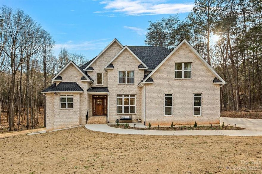 Newer (Barely lived in) FULL Brick 4-Bedroom Custom Home on 3-Acres-FENCED-NO HOA! Desirable location of Indian Land, SC. High-end finishes & Custom Light fixtures! GORGEOUS 4" White oak floors, White Cabinets w/soft close Drawers. Quartz countertops w/Large Kitchen Island & Breakfast Bar. SS Appliances & Range hood. Large open Gathering Rm adjoins Kit & Keeping room. Private Primary Bedroom ensuite w/ Delux bath boasts Quartz Vanities, Tiled floor & Dble person Jacuzzi. Second Level w/White oak flooring thru out. Large secondary Bedrooms have "Jack & Jill" Full Bath. HUGE Bonus/Media Room! Impressive, Fully Finished Basement. Living Rm-Rec Rm-Bed/Bonus-Office & Saferoom/Canning room. Great 4 Entertaining w/Walk out Patio! Designated fenced garden area, fruit trees-sheds-chicken coops ready for your mini-farm. RINNAI tankless heater. Wired for back-up generator. If sold w/adjoining lot, total of 5.317 ac is fenced. ****NOTE: SALE INCLUDED BOTH PARCELS (MLS 3940811 AND MLS 3940814)