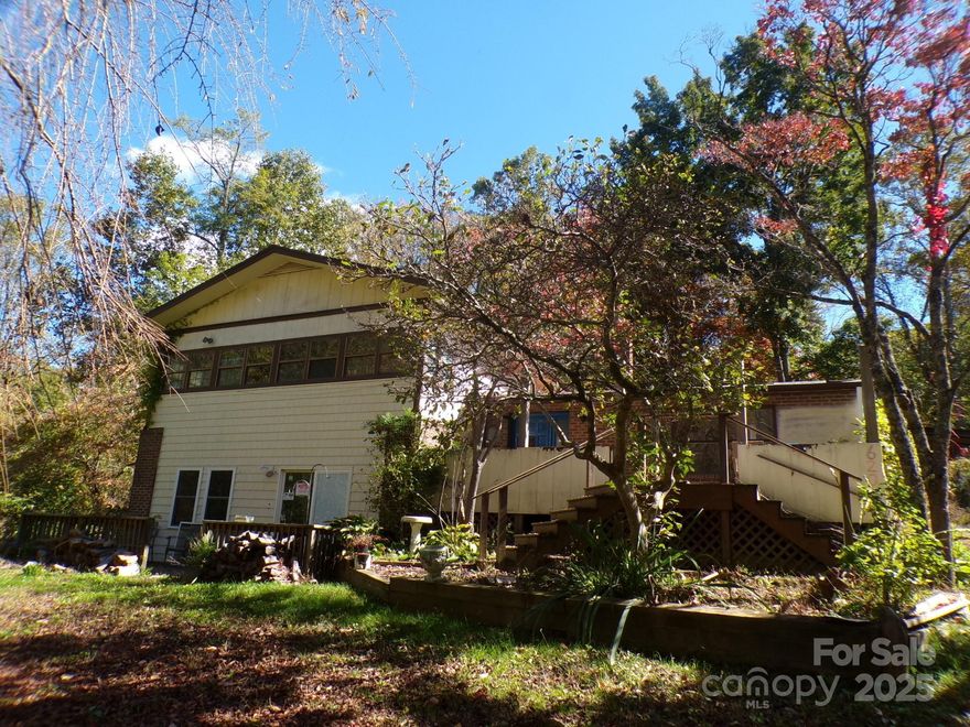 Split level home with a full finished basement on 3 acres in a private setting on the side of Hutch Mountain. Home is in need of full renovations. There is a large barn with a workshop area.  There is a front deck framed for finishing to add an enclosed or screened porch.   There is an enclosed porch off the upper level bedroom. The seller inherited the property and has not lived there since 1996. There are no warranties as to condition and the property is being sold as is. At one time, the owners had an upper garden and a lower garden filled with vegetables every year. An annual "Pig Pickin" was held every year at the barn for friends and family. The wild flowers brought off the mountain are still peaking up from the overgrowth. This property has been in the same family for over 30 years and waiting for someone to love it again. The seller does not have information about the systems or fixtures or condition.