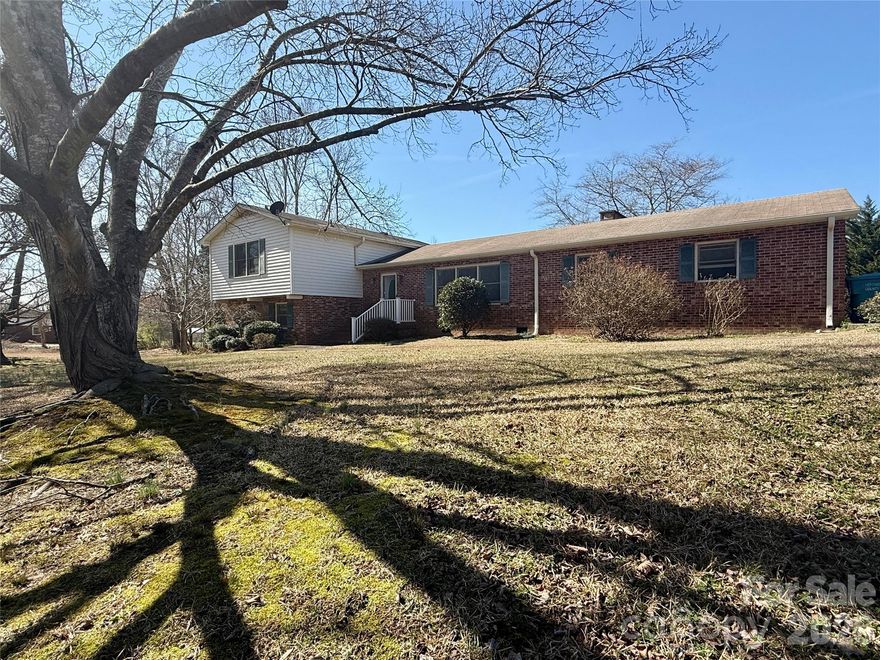 Nestled on a spacious 1-acre lot, This solid, well-built home has been lovingly maintained and offers a fantastic opportunity for cosmetic updates to reflect your personal style. With great bones, spacious rooms, and a functional layout, it’s the perfect canvas for modern touches while preserving its original character.  

On the main level, you will find the kitchen with abundant cabinetry and workspace, and a living/dining room combo with a wood-burning fireplace.  Just steps away, a large sun-filled den provides additional living space.

Heading upstairs you’ll find a split layout - two well-proportioned bedrooms and a full bath on one end (one with great built-ins perfect for school work or a home office) with the primary suite and bath on the other. 

The lower level walk-out basement offers excellent storage, laundry hook ups, a 1/2 bath and offers additional living space for a movie room, hobbies or projects... really whatever you want to make it!

Outside, the expansive yard provides privacy, mature trees, and plenty of room for gardening, recreation, or play time!  A 2-car attached carport adds everyday convenience along with a large wooden rear deck to entertain on - and the wired workshop is a standout feature — perfect for woodworking, mechanics, or anyone needing dedicated workspace. 

Whether you’re looking for a move-in ready home with vintage character or a property to personalize and make your own, this one offers incredible potential in a peaceful setting.