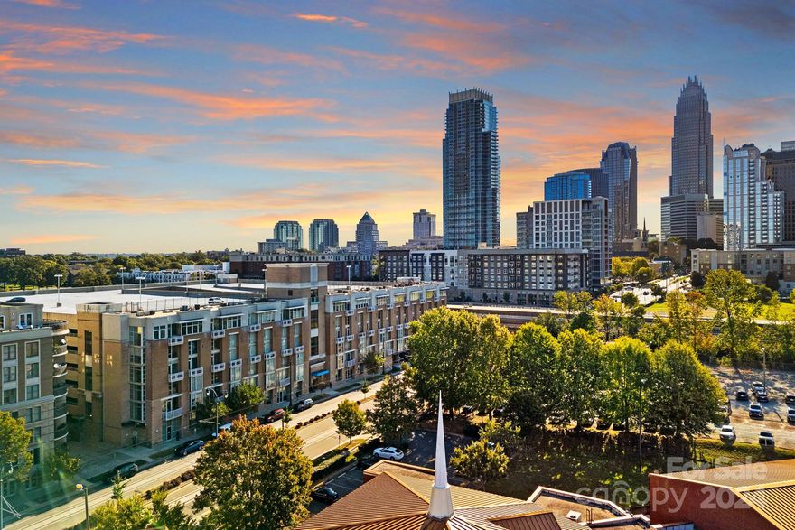 RARE large corner unit in the heart of Uptown Charlotte! Located on the 5th floor- this two-story unit offers views of the city skyline including the Panthers stadium. With industrial flair, this condo features exposed brick and concrete walls. You'll also find hardwood flooring, granite countertops, SS appliances, and more. The main level features a spacious kitchen, living, and dining area filled with natural light and an abundance of windows for beautiful city views. Head upstairs to your expansive primary bedroom, lounge area, and full bathroom with a large closet. Ample space for a work-from-home setup! Reserved same-level parking spot and CityLYNX Gold line access right outside your door! Schedule a showing today and start living that Uptown lifestyle!