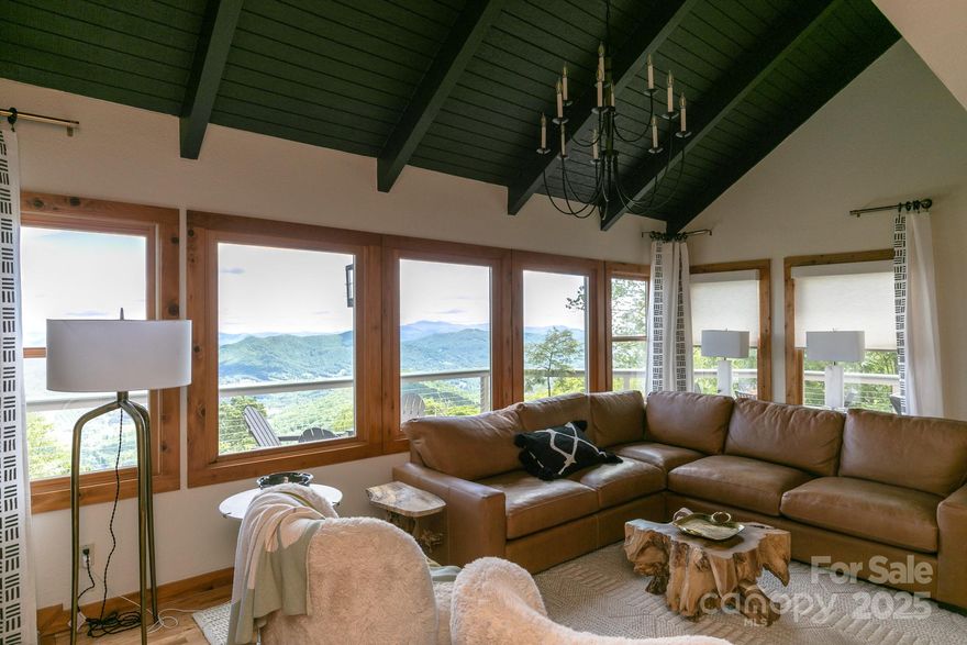 FULLY FURNISHED 3 Level, 4/4 MOUNTAIN AIR home at 4,300 feet with 180-degree spectacular endless mountain view including Grandfather Mountain and downtown Burnsville valley from the spacious main level deck, offering spectacular sunrise & sunset views. Vaulted ceilings in the great room along with a stone fireplace, creating a lovely space for gathering & entertaining. The open floor plan allows long-range views to extend to the dining area & the kitchen, with its granite countertops & generous cabinetry. The main floor has primary en suite with double vanity, tiled floor & large walk-in shower, guest BR & separate full bath & laundry room. The upstairs suite with outside deck includes built-in workspace & bath. Private lower level opens into a large room that would be a great office area, study, or another bedroom suite & features another bath ensuite with access to a secluded outside deck with more amazing views. One-car garage & cart garage. Furnishings & golf cart included.